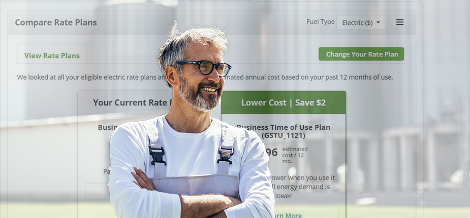 Farmer standing in front of a bank of grain silos, with an image of  the rate finder tool from the business energy use dashboard behind him.